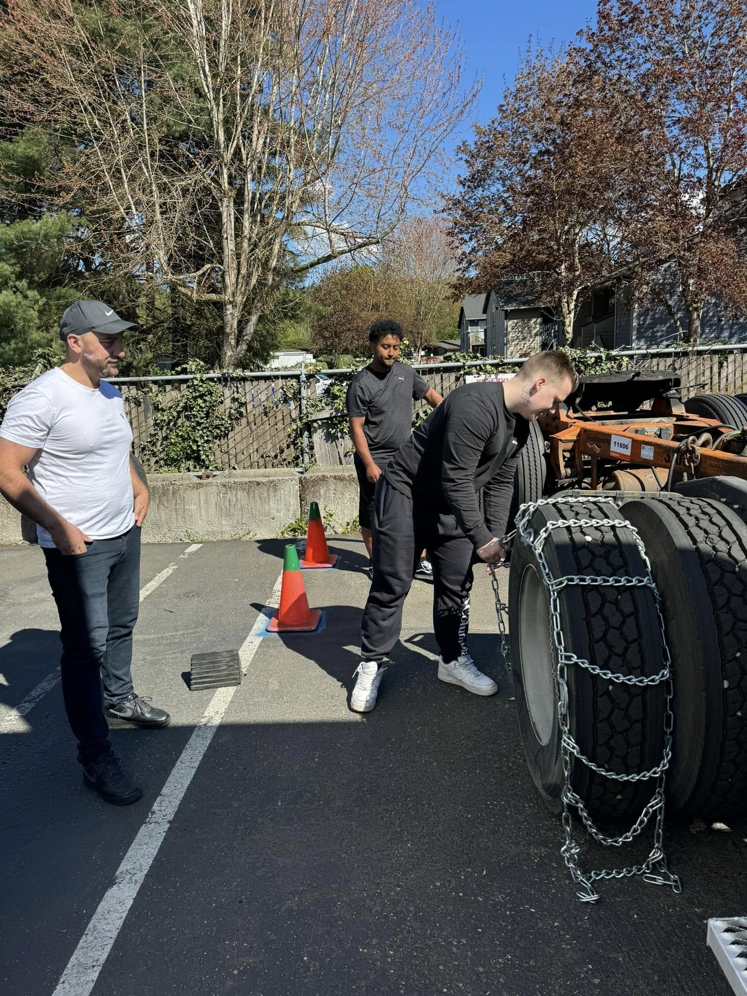 Students practicing tire chain installation