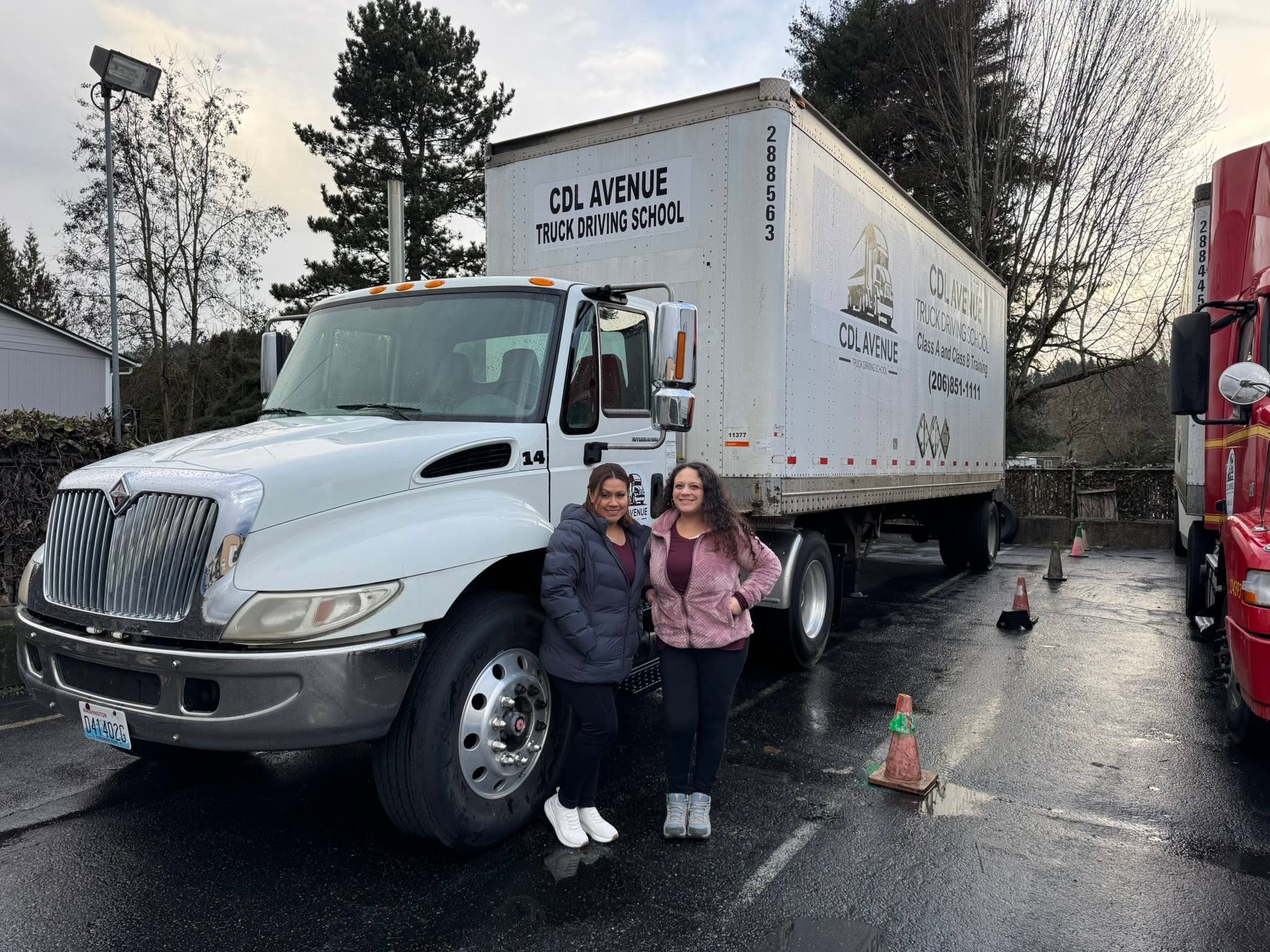 Two students in front of CDL Avenue truck