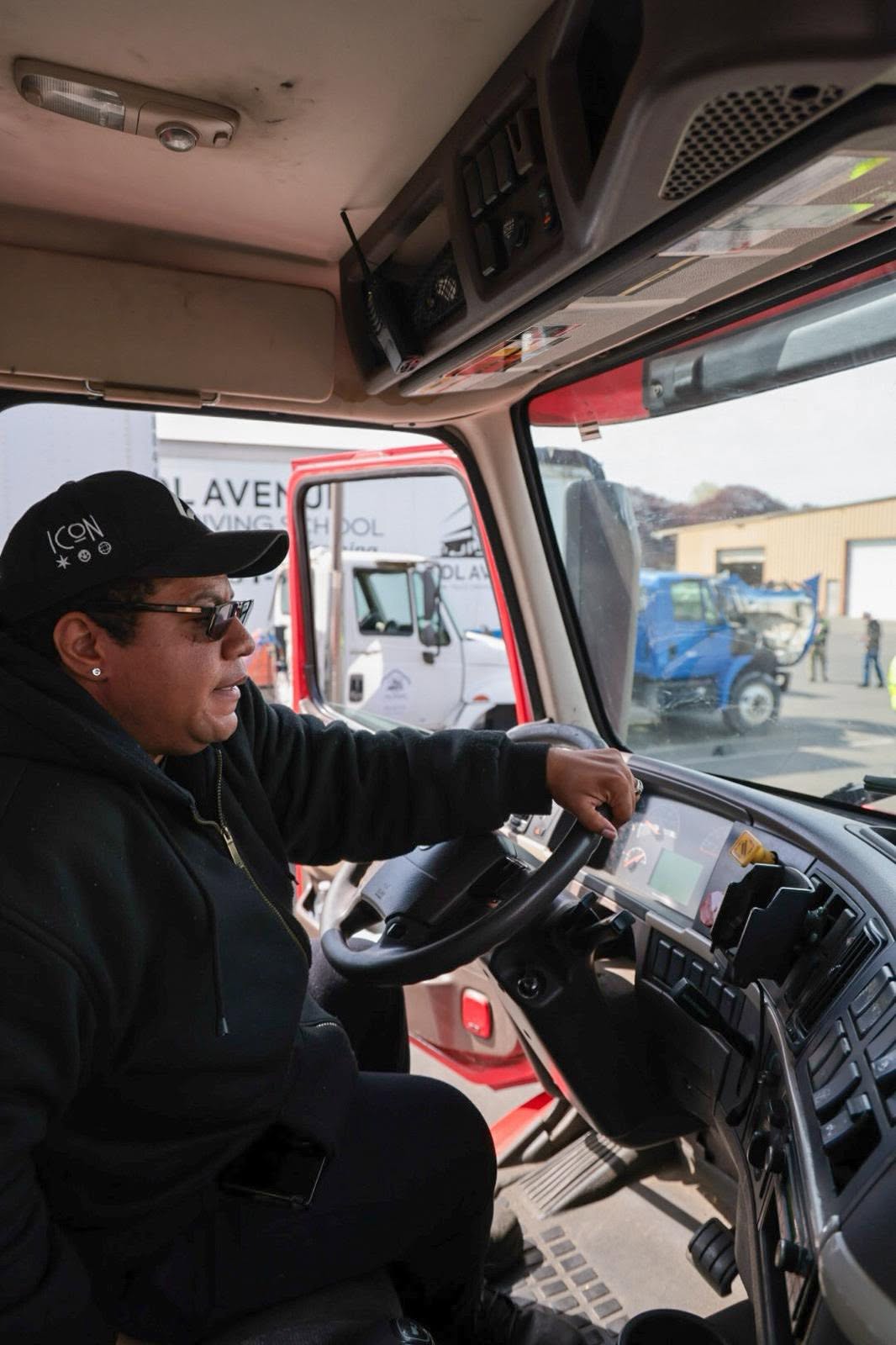 Instructor behind the wheel of a training truck